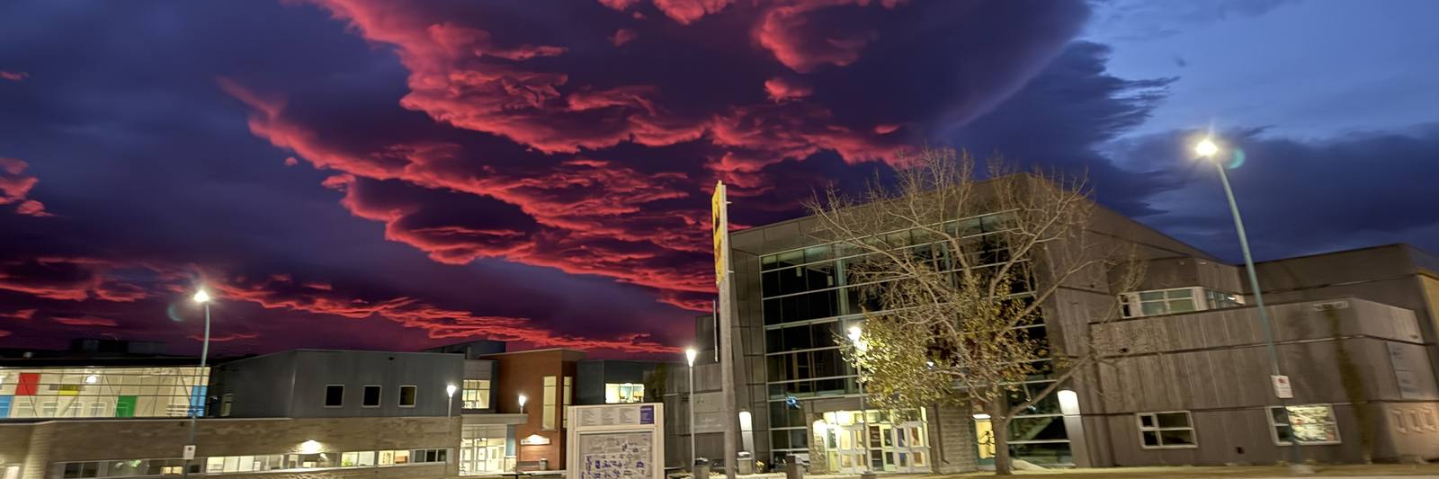 Red and purple sunset clouds over the Ralph Klein Centre in Olds, Alberta